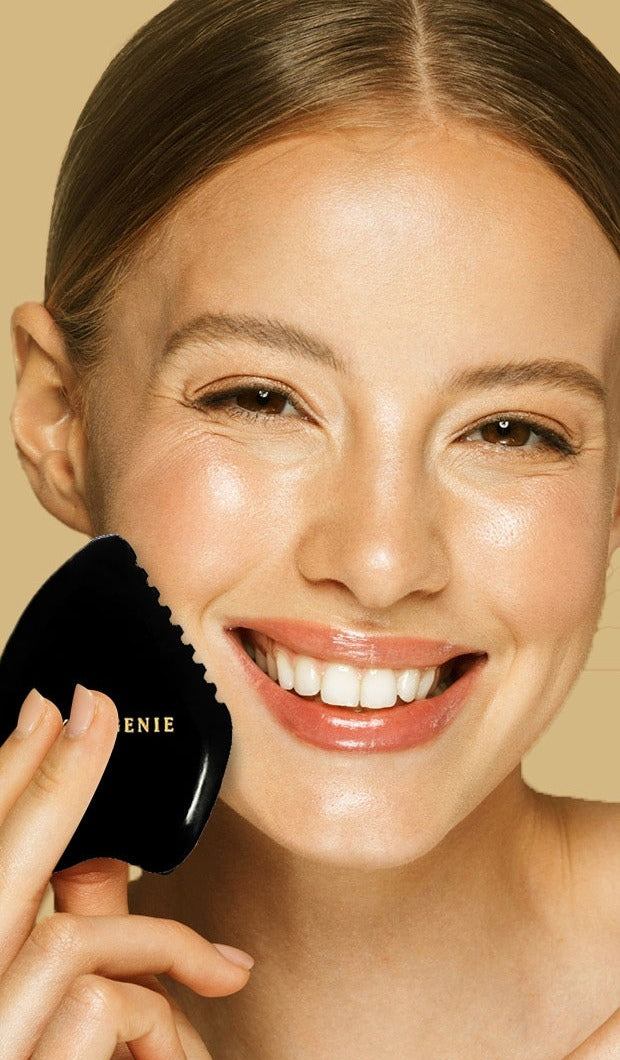 The five-edge bian stone gua sha held against the cheek