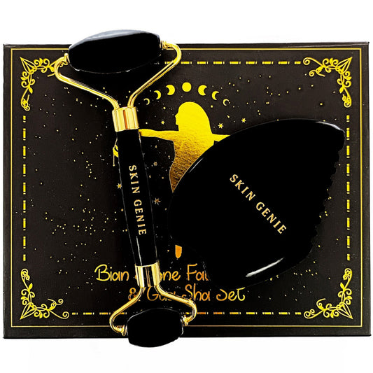 Bian stone gua sha and face roller resting on the gift box