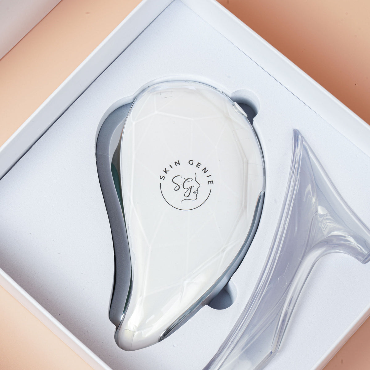 La Beauté electric gua sha in its gift box with the stand