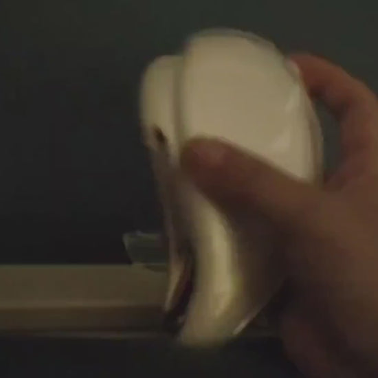 The electric gua sha cycling through its warm, cool, and light modes in a dark room